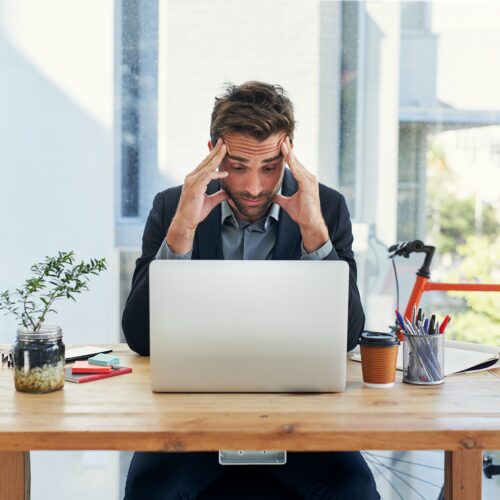 Laptop,,Headache,And,Businessman,With,Stress,In,Office,For,Report,