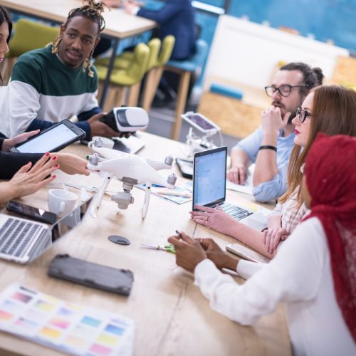 Multiethnic,Startup,Business,Team,Discussing,New,Business,Plan,working,On,Laptop