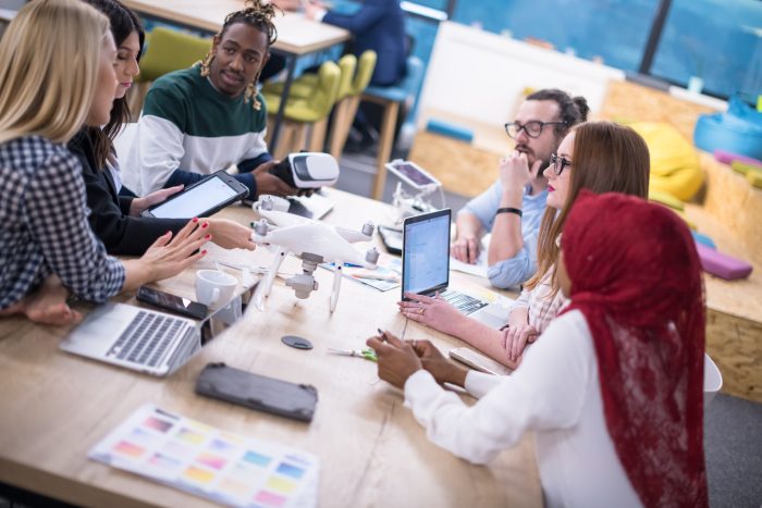 Multiethnic,Startup,Business,Team,Discussing,New,Business,Plan,working,On,Laptop